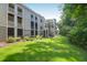 Back exterior view of condo featuring screened patios, balconies, and lush green spaces at 1300 Park West Blvd # 512, Mount Pleasant, SC 29466
