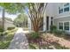Side exterior view of condo featuring sidewalks, stairs, and lush landscaping at 1300 Park West Blvd # 512, Mount Pleasant, SC 29466