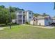 Beautiful condo building featuring private balconies, lush lawn, and convenient garage parking at 1300 Park West Blvd # 512, Mount Pleasant, SC 29466