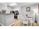 Charming kitchen and dining area with white table and chairs, complemented by modern appliances and decor at 1300 Park West Blvd # 512, Mount Pleasant, SC 29466