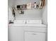 Functional laundry room with washer, dryer, and storage shelving for convenience and organization at 1300 Park West Blvd # 512, Mount Pleasant, SC 29466