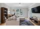 Inviting living room with a comfortable couch, work space and a flatscreen TV at 1300 Park West Blvd # 512, Mount Pleasant, SC 29466