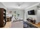 Bright living room with wood floors, a view of the window and a flatscreen TV at 1300 Park West Blvd # 512, Mount Pleasant, SC 29466