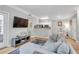 Open living room with wood floors and a view of the dining area and kitchen at 1300 Park West Blvd # 512, Mount Pleasant, SC 29466