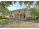 Back of the home, featuring a screened porch, brick patio, and spacious backyard lawn at 1308 Wild Olive Dr, Mount Pleasant, SC 29464