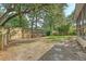 A spacious, grassy backyard featuring a wooden fence and a screened-in porch attached to the home at 1308 Wild Olive Dr, Mount Pleasant, SC 29464