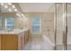 Bathroom featuring double sinks, bath tub, and large mirror at 1308 Wild Olive Dr, Mount Pleasant, SC 29464