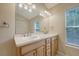 Bathroom featuring double sinks, large mirror, and natural light at 1308 Wild Olive Dr, Mount Pleasant, SC 29464