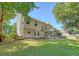The back exterior of the house shows a well-kept lawn, an outdoor patio, and a screened in porch at 1308 Wild Olive Dr, Mount Pleasant, SC 29464