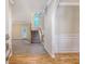 Spacious foyer with hardwood floors, carpeted stairs, and an arched entryway to the living spaces at 1308 Wild Olive Dr, Mount Pleasant, SC 29464