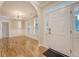 Inviting foyer entrance with natural light and hardwood floors flowing into the dining area at 1308 Wild Olive Dr, Mount Pleasant, SC 29464
