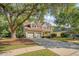 Charming two-story home with a well-manicured lawn, mature trees, and a two-car garage at 1308 Wild Olive Dr, Mount Pleasant, SC 29464