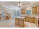 Bright kitchen featuring an island, light wood cabinets, and tile floors, seamlessly connecting to the dining area at 1308 Wild Olive Dr, Mount Pleasant, SC 29464