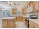 Well-lit kitchen featuring light wood cabinets, white countertops, and stainless steel appliances at 1308 Wild Olive Dr, Mount Pleasant, SC 29464