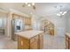 Bright kitchen with a center island, stainless steel refrigerator and access to the staircase at 1308 Wild Olive Dr, Mount Pleasant, SC 29464