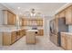 Traditional kitchen featuring wood cabinetry, an island, stainless steel appliances, and neutral countertops at 1308 Wild Olive Dr, Mount Pleasant, SC 29464