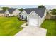 Aerial view of the home's light-gray siding, black roof, attached one car garage, and lush green yard at 137 Salem Creek Dr, Goose Creek, SC 29445