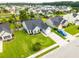 Wide aerial view showcasing the home and surrounding neighborhood, with lush lawns, a blue pickup, and mature trees at 137 Salem Creek Dr, Goose Creek, SC 29445