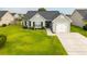 Well-maintained single-story home with an attached one car garage, dark roof, and beautiful landscaping at 137 Salem Creek Dr, Goose Creek, SC 29445