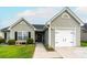 Charming single-story home featuring a manicured lawn, light-gray siding and an attached one car garage at 137 Salem Creek Dr, Goose Creek, SC 29445