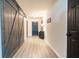 Spacious hallway featuring a rustic barn door and inviting entryway with stylish accents at 137 Salem Creek Dr, Goose Creek, SC 29445