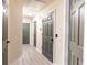 Hallway showcasing modern gray wood-look floors, neutral walls, and multiple gray doors at 137 Salem Creek Dr, Goose Creek, SC 29445