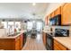 This open kitchen features wood cabinets, modern black appliances, and a cozy breakfast nook at 137 Salem Creek Dr, Goose Creek, SC 29445