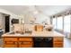 Open kitchen area with stainless steel sink, black dishwasher, and wood cabinets at 137 Salem Creek Dr, Goose Creek, SC 29445