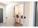 A well-lit laundry room featuring a washer, dryer, and wire shelving at 137 Salem Creek Dr, Goose Creek, SC 29445