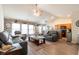 Bright living room with vaulted ceilings, brick accent wall and open layout to kitchen at 137 Salem Creek Dr, Goose Creek, SC 29445