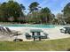 Community swimming pool with picnic tables and plenty of lounge chairs for residents at 137 Salem Creek Dr, Goose Creek, SC 29445