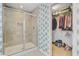 Modern bathroom featuring a glass-enclosed shower and an adjacent walk-in closet at 142 Elliott Creek Ln, Summerville, SC 29485