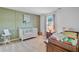 Charming Bedroom featuring paneled accent wall, a crib, and a changing table at 142 Elliott Creek Ln, Summerville, SC 29485