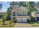 Charming two-story home with a well-manicured lawn and inviting curb appeal, complemented by mature trees at 142 Elliott Creek Ln, Summerville, SC 29485