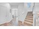Bright hallway with hardwood flooring, stairs, and multiple doorways for easy access to rooms at 142 Elliott Creek Ln, Summerville, SC 29485