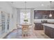 A well-lit kitchen nook with rustic wood table, pendant lighting, and stainless steel appliances at 142 Elliott Creek Ln, Summerville, SC 29485