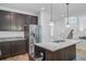 Contemporary kitchen with a large island, stainless steel refrigerator, and dark wood cabinetry at 142 Elliott Creek Ln, Summerville, SC 29485