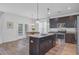 Modern kitchen with dark cabinets, granite countertops, stainless steel appliances, and an island at 142 Elliott Creek Ln, Summerville, SC 29485