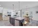 Open-concept kitchen with a central island, granite countertops, and seamless flow to the living area at 142 Elliott Creek Ln, Summerville, SC 29485
