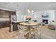 Open-concept living room with fireplace, plush seating, and views into the kitchen and dining area at 142 Elliott Creek Ln, Summerville, SC 29485
