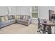 A bonus room featuring a comfortable sectional sofa, a desk setup, and ample natural light at 142 Elliott Creek Ln, Summerville, SC 29485