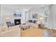 Bright, airy living room with a fireplace, cozy seating, and natural light from the windows at 142 Elliott Creek Ln, Summerville, SC 29485