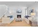 Bright living room featuring a fireplace, comfortable sofas, and a patterned ottoman at 142 Elliott Creek Ln, Summerville, SC 29485