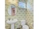 Charming powder room featuring patterned wallpaper, a round mirror, and a pedestal sink at 142 Elliott Creek Ln, Summerville, SC 29485