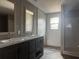 Bathroom featuring double vanity with dark cabinets, modern faucets, and a walk-in shower creating a spa-like experience at 1420 Rehoboth Rd, Cottageville, SC 29435