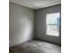 A sunlit bedroom features sleek gray floors and neutral wall decor at 1420 Rehoboth Rd, Cottageville, SC 29435