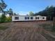 New manufactured home with dark shutters on a spacious lot surrounded by mature trees under clear skies at 1420 Rehoboth Rd, Cottageville, SC 29435