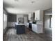 Modern kitchen with white cabinets, stainless steel appliances, kitchen island, and hardwood floors that offer modern appeal at 1420 Rehoboth Rd, Cottageville, SC 29435