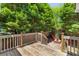 Wooden back deck with stairs leading to patio and charming outdoor seating at 1441 Waterside Ct, Mount Pleasant, SC 29464