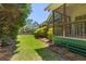 Lush backyard featuring a screened porch and charming garden at 1441 Waterside Ct, Mount Pleasant, SC 29464